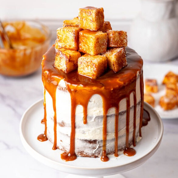 Sticky toffee pudding cake on a cake stand.