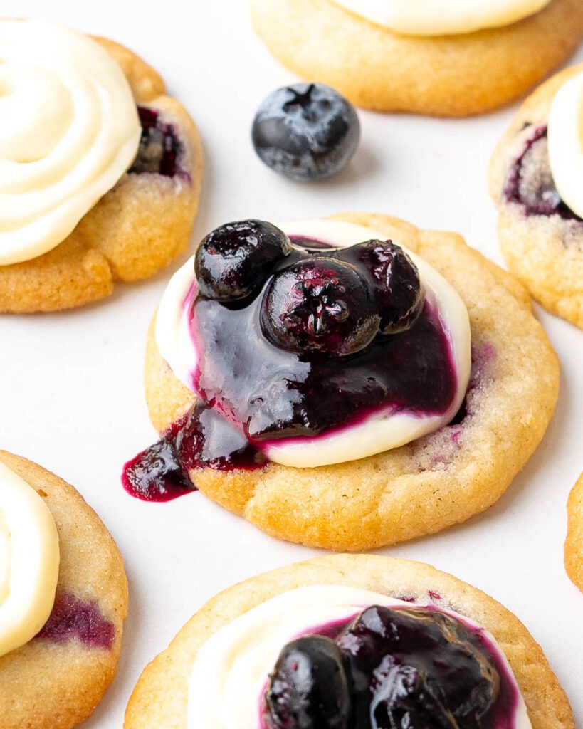 Close up image of a mini blueberry cheesecake cookie.