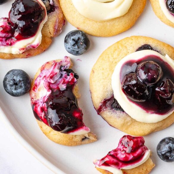 Mini blueberry cheesecake cookies on a plate.