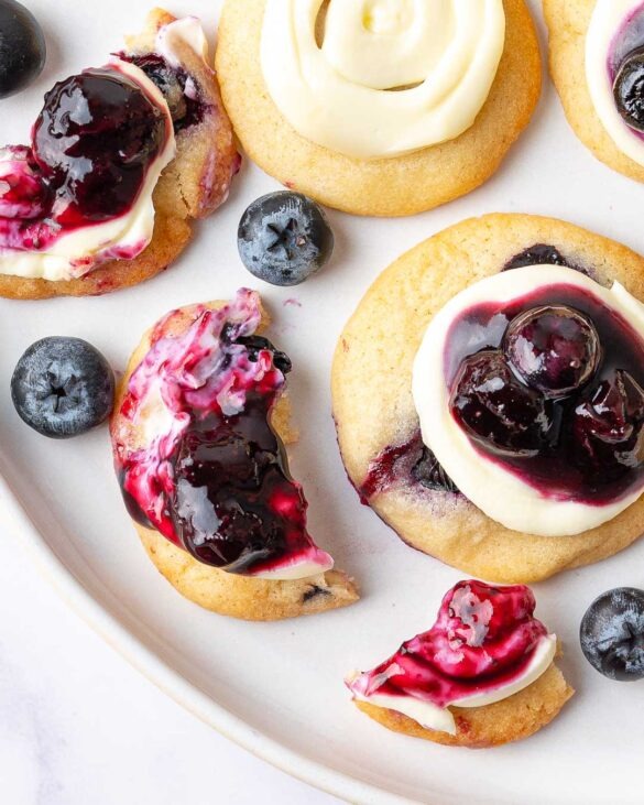 Mini blueberry cheesecake cookies on a plate.