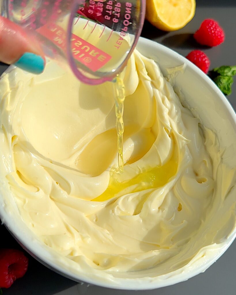 Limoncello poured in a bowl of ice cream mixture in a bowl.