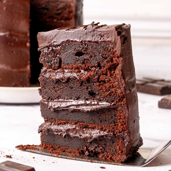 Slice of chocolate mud cake on a cake slice.