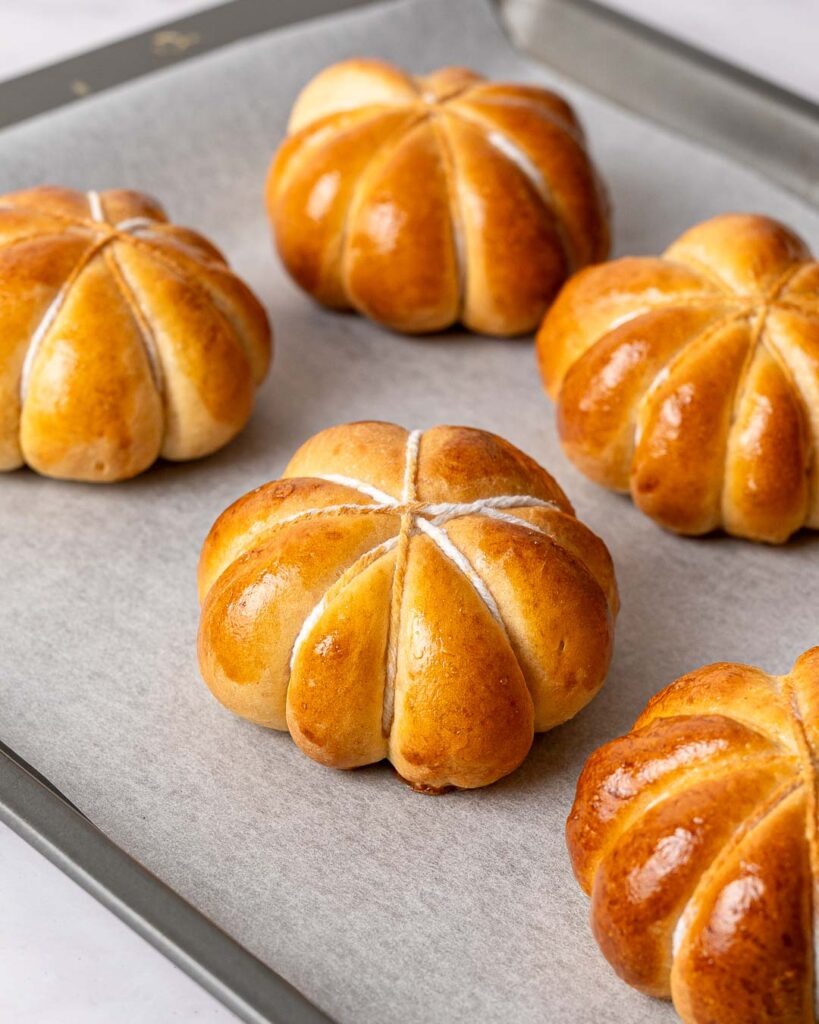 Pumpkin shaped buns wrapped in string after being baked in the oven.