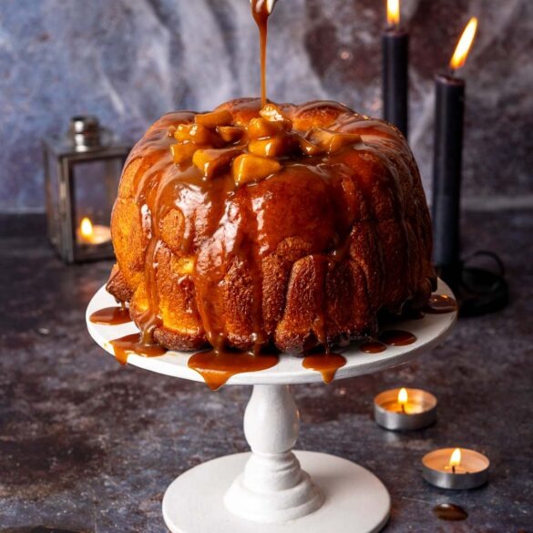 Apple pie monkey bread on a cake stand.