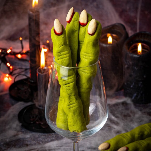 Witch finger shortbread cookies in a wine glass.