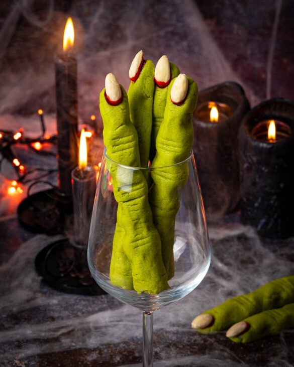 Witch finger shortbread cookies in a wine glass.