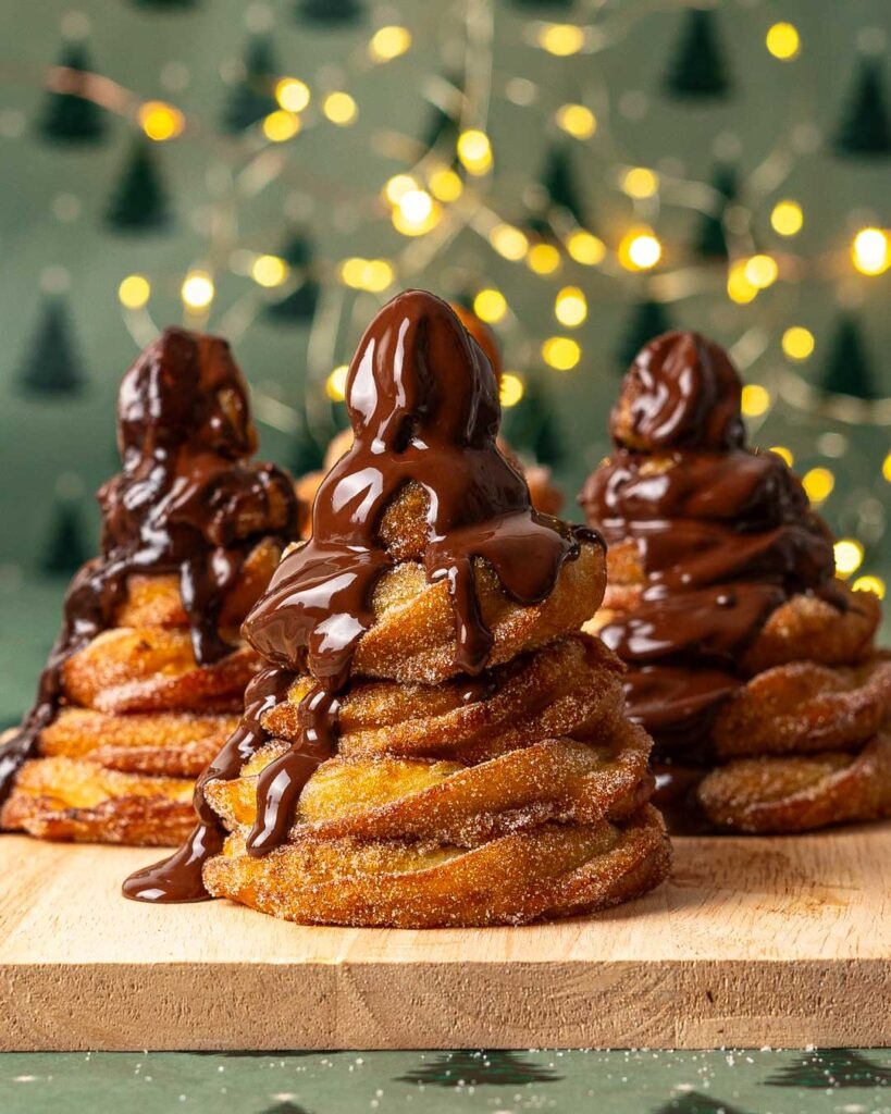 Churro christmas trees with melted chocolate running down. 