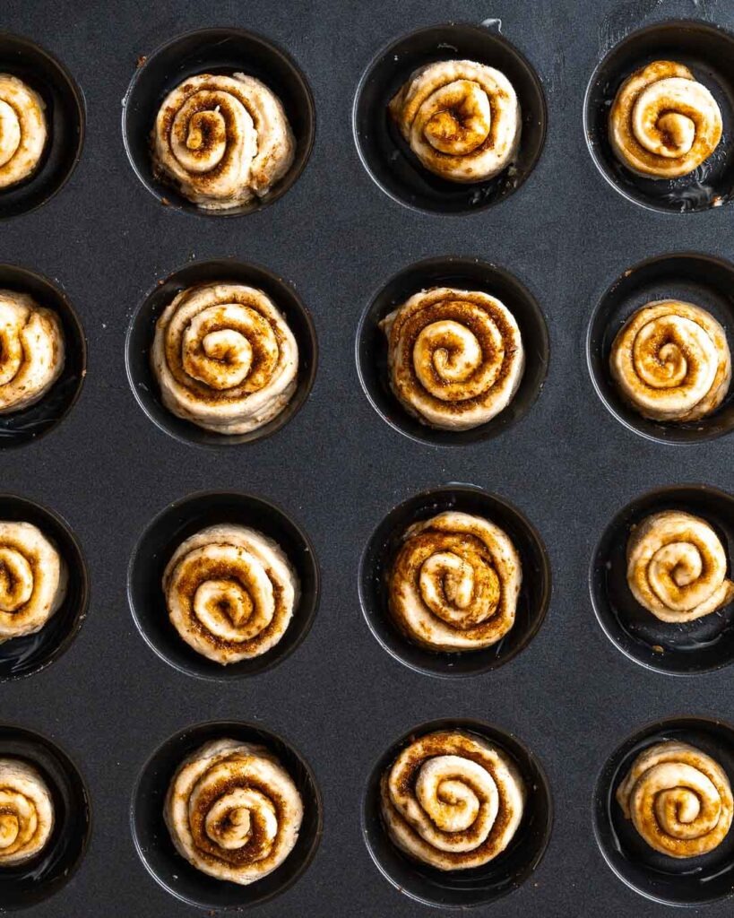 mini cinnamon rolls in a cupcake tin before being baked.