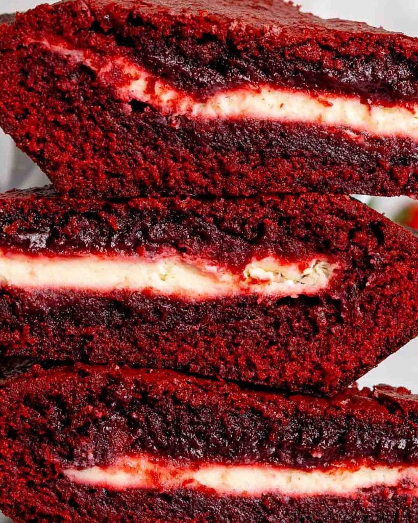 Three slices of red velvet brownie pie stacked on top of each other.