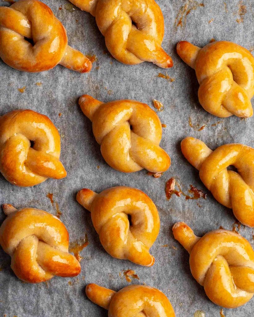 Pretzel knots on a baking tray.