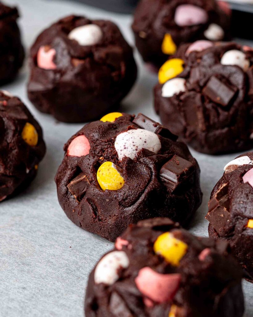 Mini egg cookie dough balls on a baking tray.