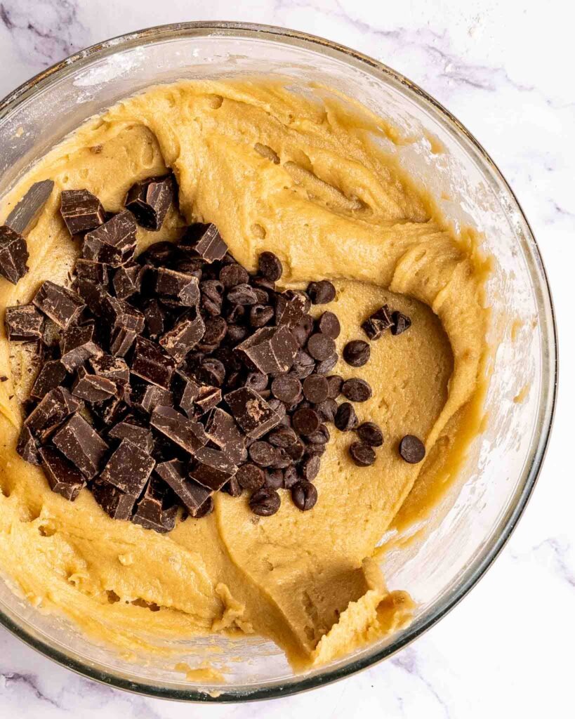 Blondie dough in a bowl with chocolate chips.