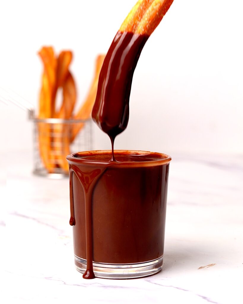 Churros dipped in chocolate sauce.