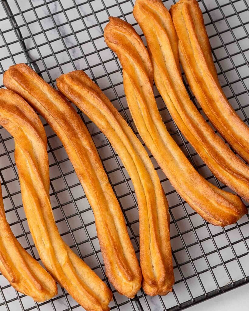 Churros on a cooling rack.