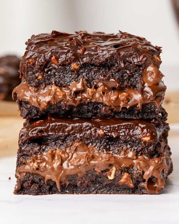 A stack of two Ferrero Rocher brownies with a rich Nutella and nut filling, showcasing a fudgy texture and crunchy hazelnut layers.