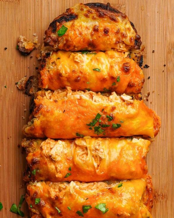 Sliced cheesy peri peri garlic bread on a board.