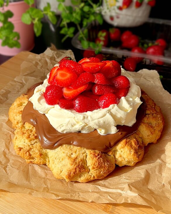 Giant Strawberry Shortcake with Nutella, cream and strawberries on top.