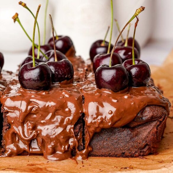 Ferrero rocher black forest cake covred in nutty nutella and fresh cherries.
