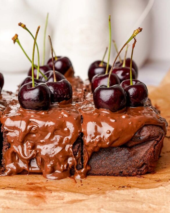 Ferrero rocher black forest cake covred in nutty nutella and fresh cherries.