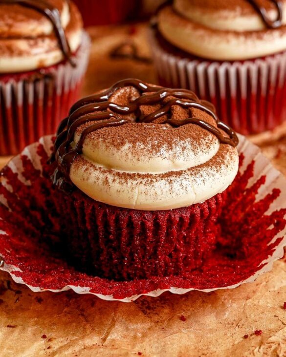 Red velvet cupcake with tiramisu cheesecake frosting on top.