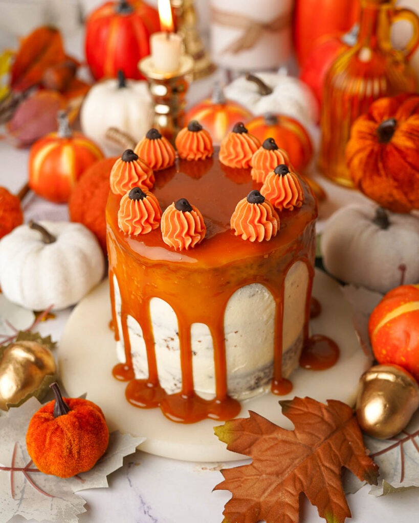 Mini-Sticky-toffee-pudding-cake-cozy-fall-dessert.jpg - Ems Foodie Fix Mini sticky toffee pudding with a caramel drizzle and tiny buttercream pumpkins on top.