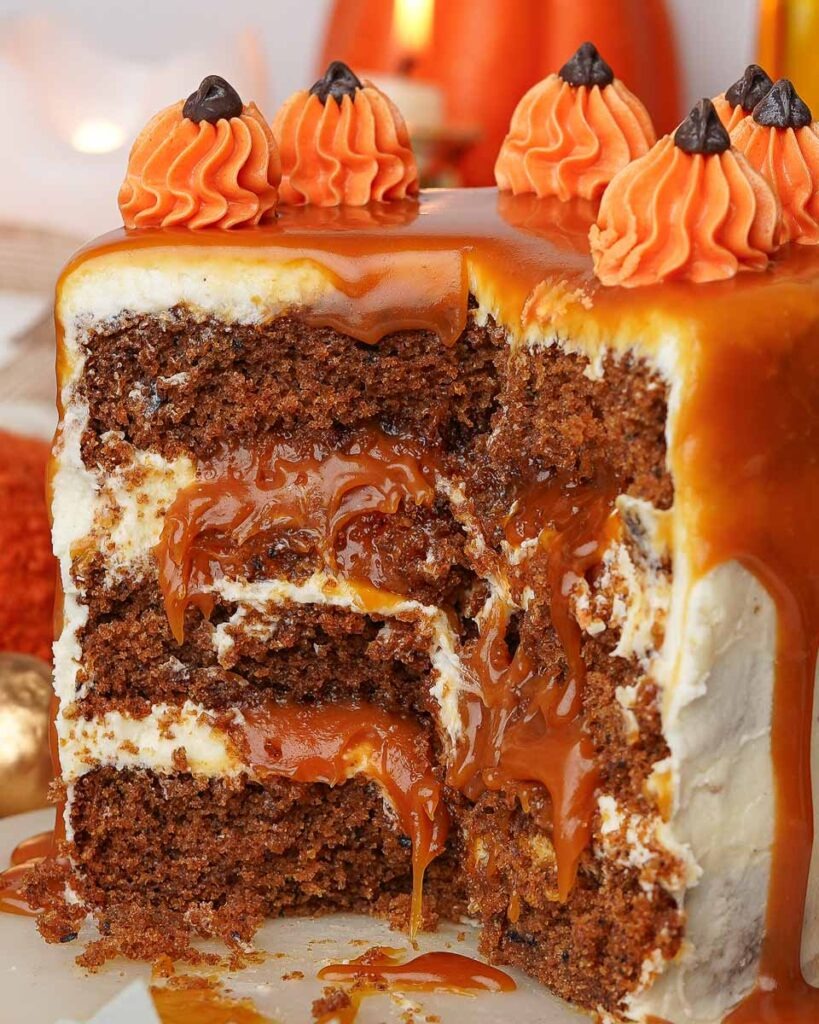 Mini-Sticky-toffee-pudding-cake-cozy-fall-dessert.jpg - Ems Foodie Fix Mini sticky toffee pudding with a slice removed to reveal gooey caramel layers oozing out of the cake.