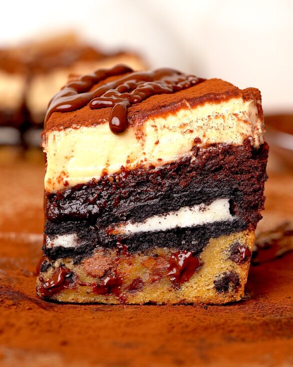 Slutty brownies with a creamy tiramisu topping dusted in cocoa and a drizzle of melted chocolate.