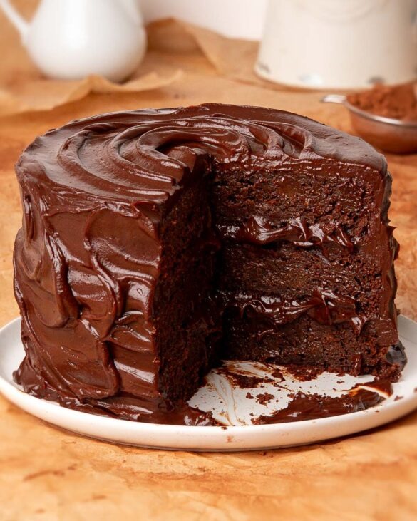 Six ingredient death by chocolate cake with a slice missing showing the inside.