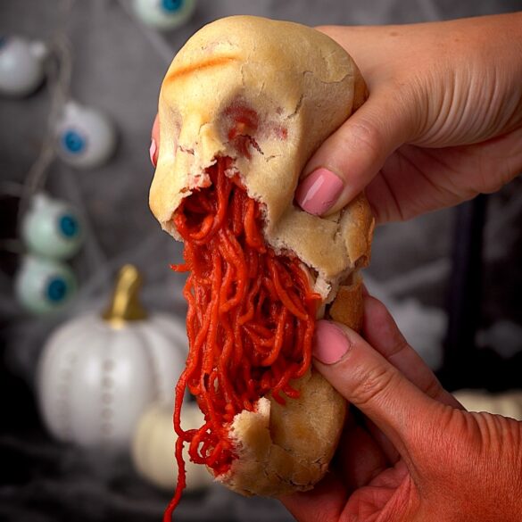 Instant-noodle-skulls-for-halloween.jpg Pizza dough skulls being pulled apart to reveal red instant noodles for halloween.