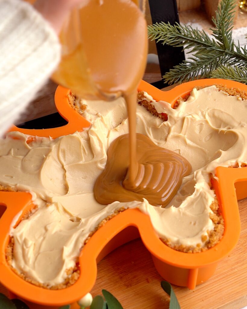 Gingerbread man shaped biscoff cheesecake served upside down.