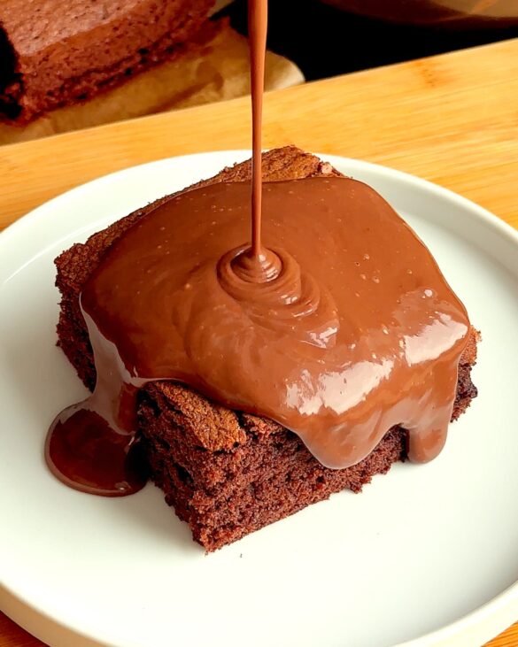 School Chocolate Sponge with Chocolate Custard being poured on top.