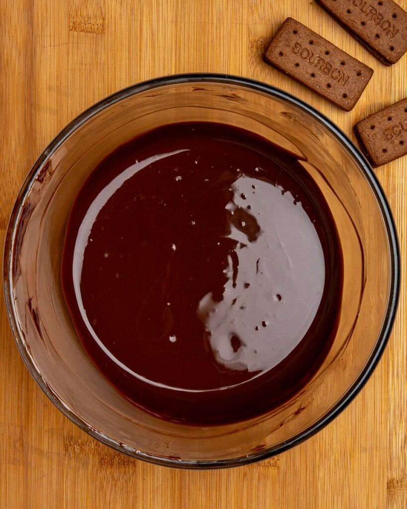 Melted chocolate and butter for fudgy bourbon biscuit brownies