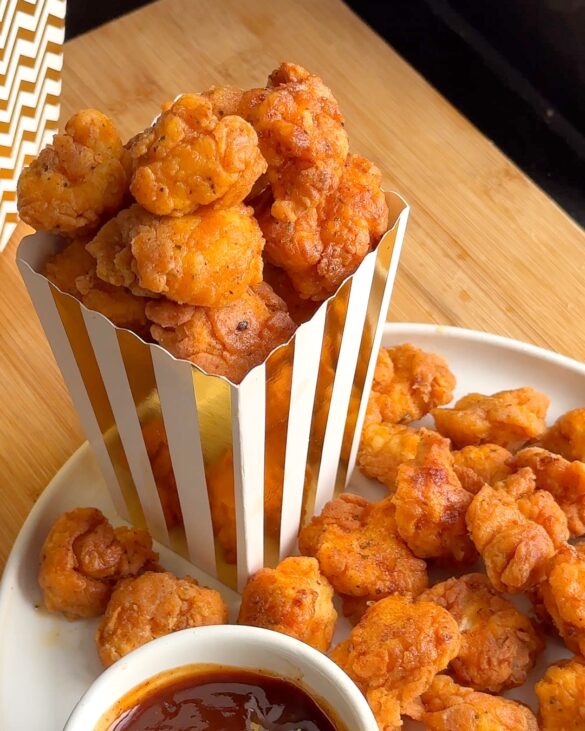 KFC style Popcorn Chicken in a white and gold stripy popcorn box.