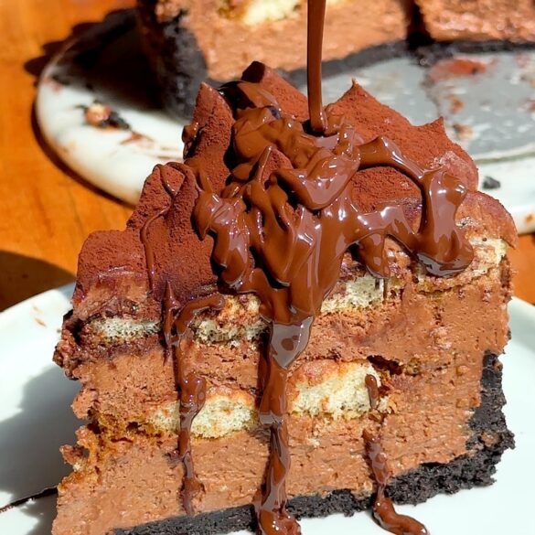 Chocolate-tiramisu-cheesecake-no-bake-summer-dessert.jpg Slice of chocolate tiramisu cheesecake with a oreo cookie crumb crust, drenched in melted chocolate drizzle.