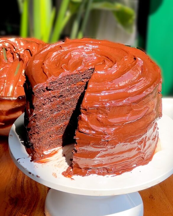 The Ultimate Chocolate Fudge Matilda Cake with a slice removed revealing a 6 layer slice.